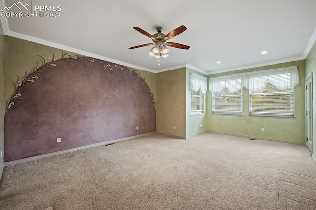 carpeted empty room with ceiling fan and ornamental molding