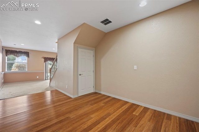 additional living space with light hardwood / wood-style flooring