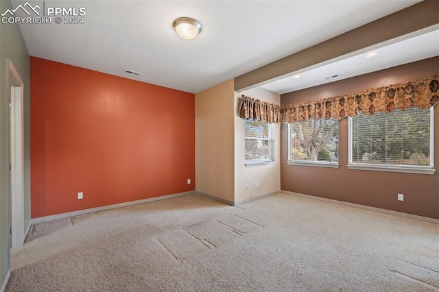 spare room with light colored carpet