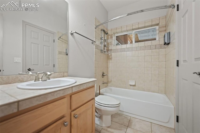 full bathroom featuring tile patterned flooring, vanity, toilet, and tiled shower / bath