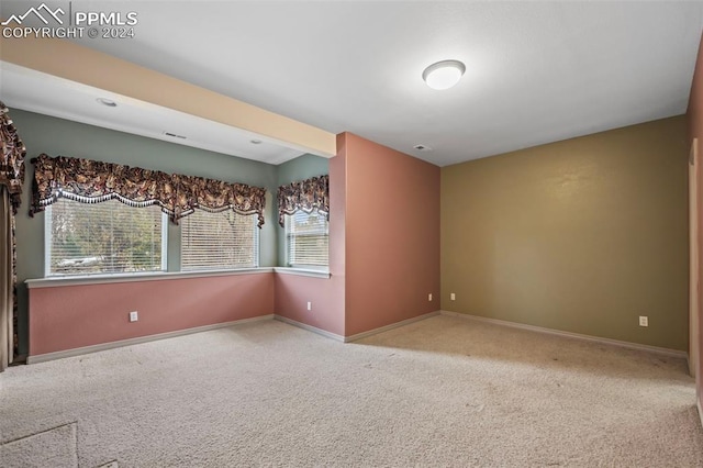 empty room featuring light carpet