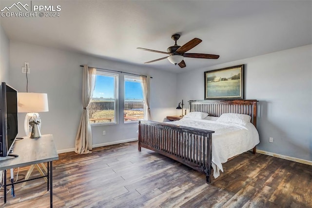 bedroom featuring ceiling fan and dark wood-type flooring