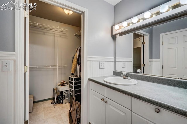 bathroom with tile patterned flooring and vanity