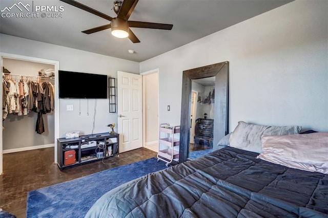 bedroom featuring ceiling fan, a walk in closet, and a closet