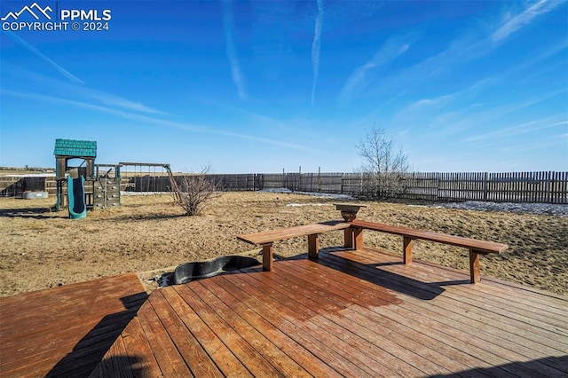 wooden terrace with a playground