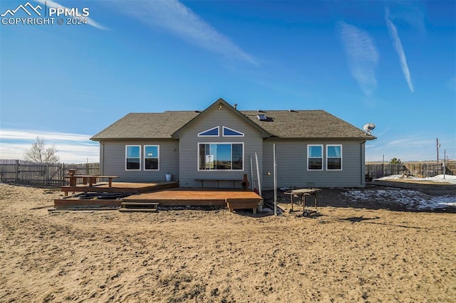 back of property featuring a wooden deck