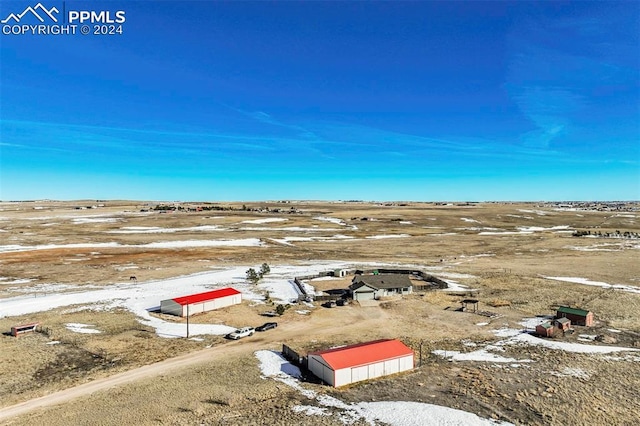 birds eye view of property with a rural view