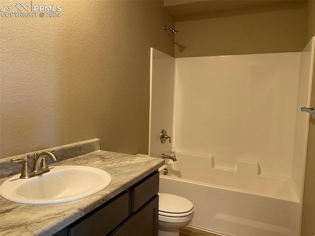 full bathroom with bathing tub / shower combination, vanity, and toilet