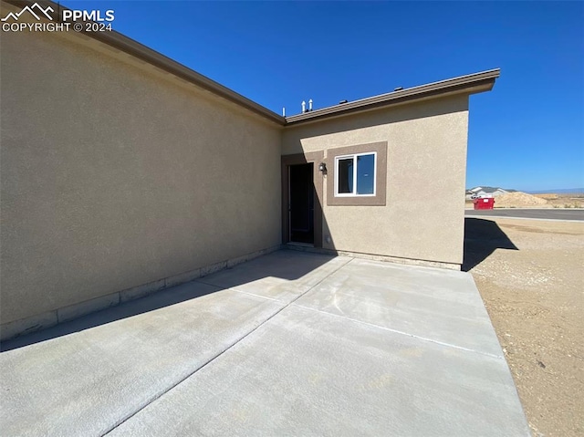 doorway to property featuring a patio area