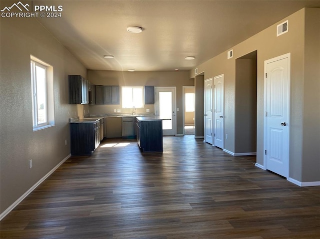 kitchen with a center island, dark hardwood / wood-style floors, and sink