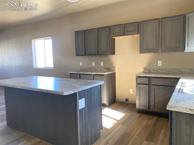 kitchen featuring hardwood / wood-style flooring, a center island, and gray cabinets