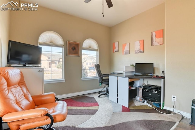 home office with hardwood / wood-style flooring and ceiling fan