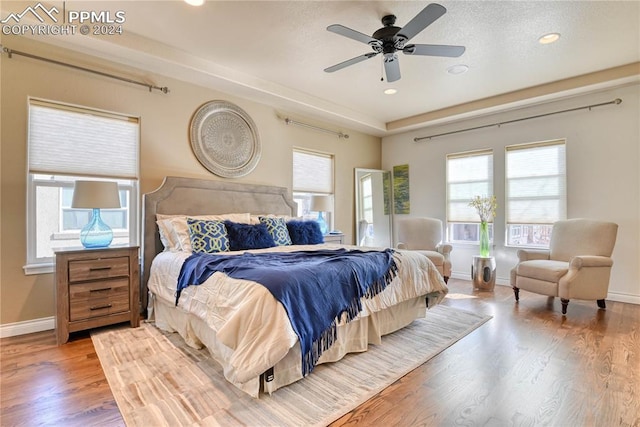 bedroom with hardwood / wood-style flooring and ceiling fan