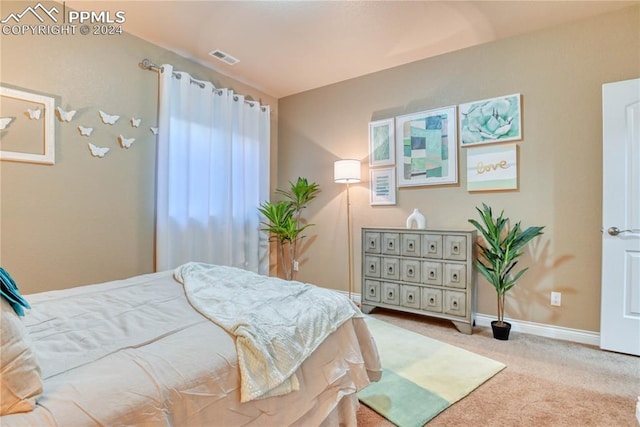 bedroom featuring light colored carpet