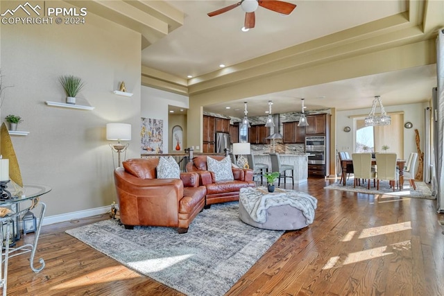 living room featuring ceiling fan and hardwood / wood-style floors