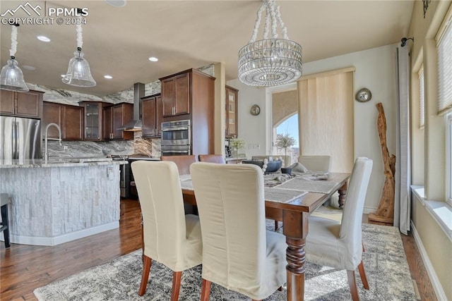 dining space with dark hardwood / wood-style flooring and a chandelier