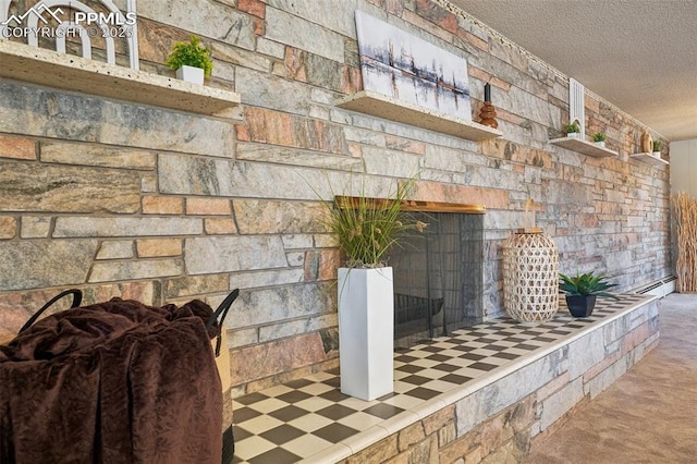 room details featuring a fireplace and a textured ceiling