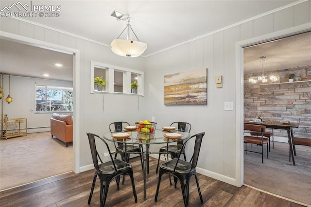 dining space with crown molding and dark wood-type flooring