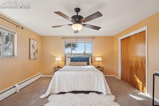 carpeted bedroom with ceiling fan and baseboard heating