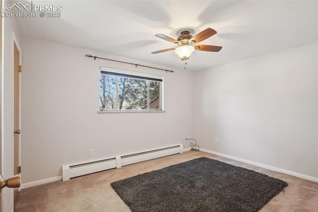 carpeted spare room featuring baseboard heating and ceiling fan