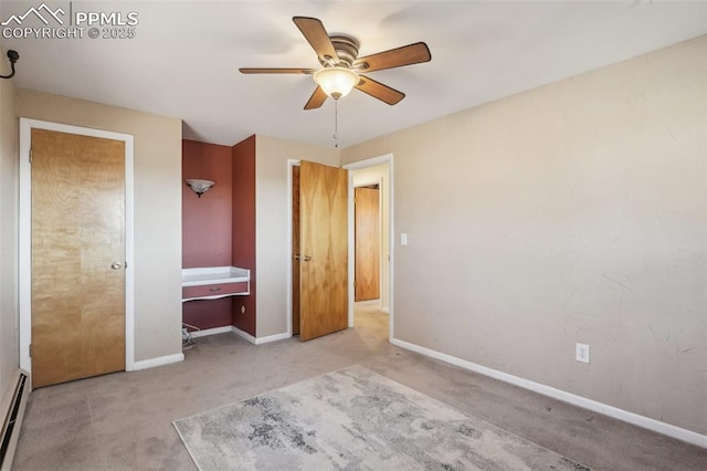 unfurnished bedroom featuring a baseboard radiator, light colored carpet, and ceiling fan