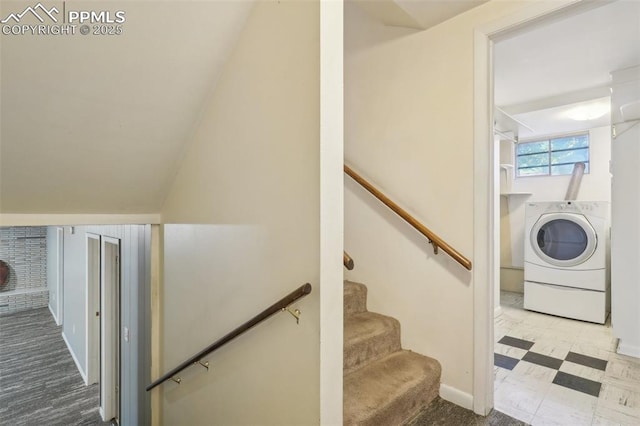 staircase with washer / dryer and vaulted ceiling