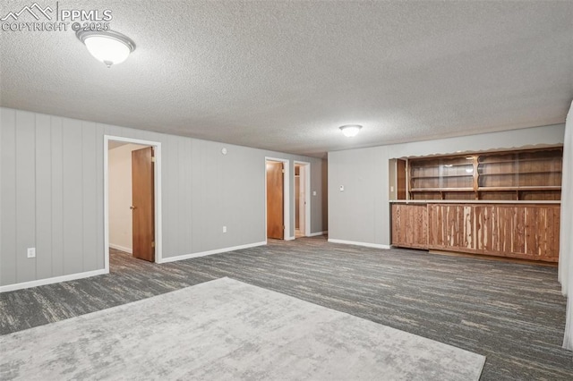 carpeted spare room with a textured ceiling