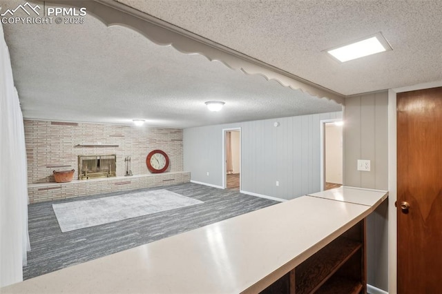 kitchen with a fireplace and a textured ceiling