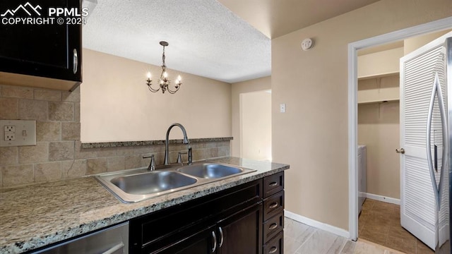 kitchen featuring backsplash, sink, hanging light fixtures, and stainless steel appliances