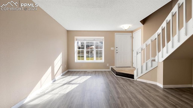 entryway featuring a textured ceiling and hardwood / wood-style flooring