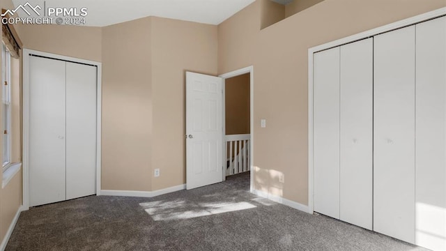 unfurnished bedroom with dark carpet