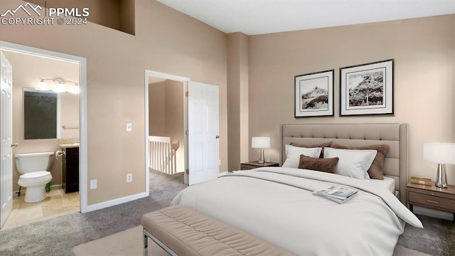 bedroom featuring light colored carpet, high vaulted ceiling, and ensuite bath