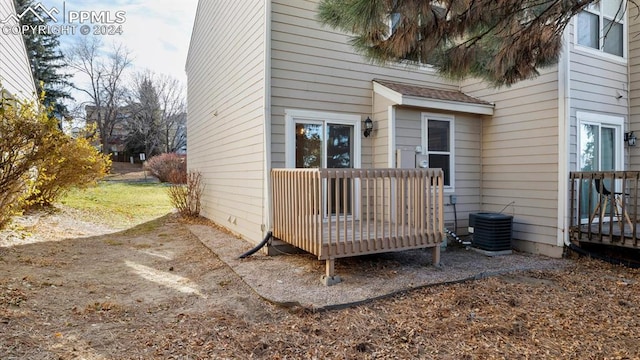 exterior space featuring a wooden deck and cooling unit