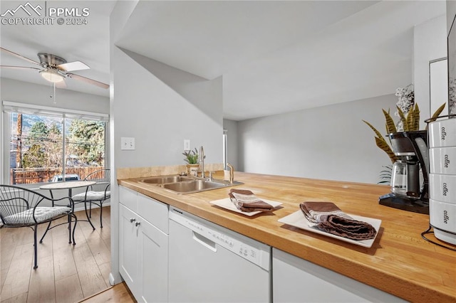 kitchen featuring ceiling fan, sink, white dishwasher, white cabinets, and light wood-type flooring