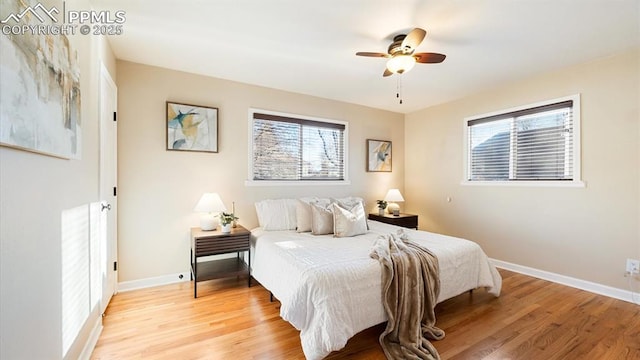 bedroom with ceiling fan and light hardwood / wood-style floors