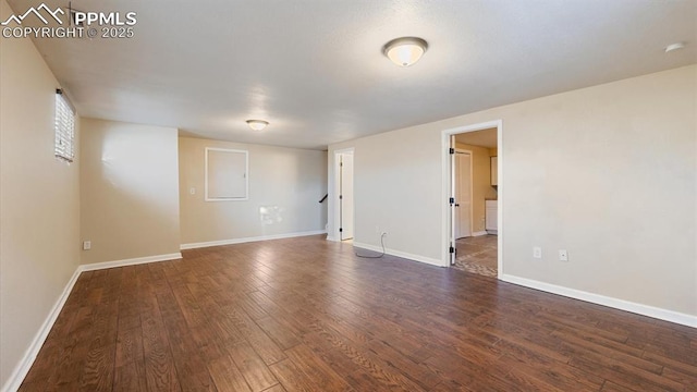 empty room with dark hardwood / wood-style floors