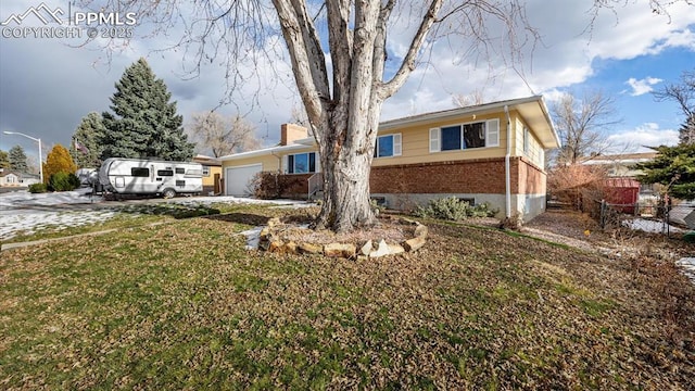 ranch-style house featuring a front yard and a garage