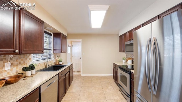 kitchen with sink, stainless steel appliances, tasteful backsplash, and light tile patterned floors