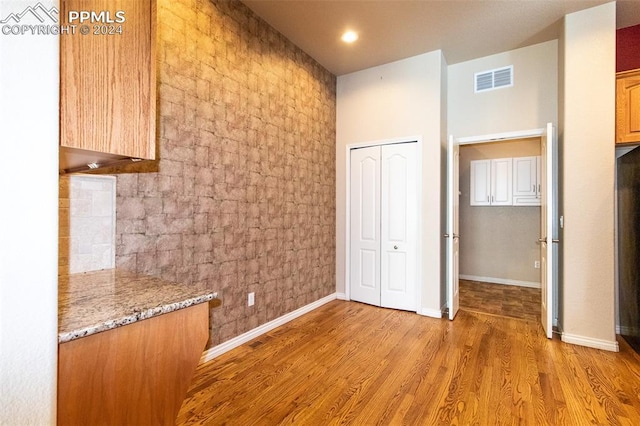 interior space featuring light wood-type flooring and light stone counters