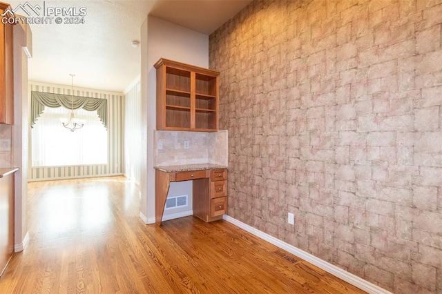 interior space featuring light hardwood / wood-style floors and a notable chandelier