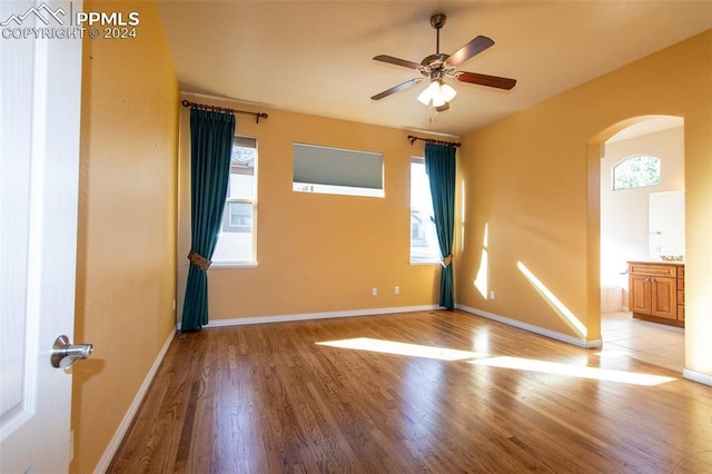 unfurnished room featuring light wood-type flooring and ceiling fan