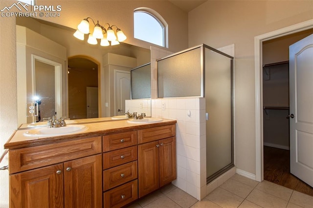 bathroom with vanity, tile patterned floors, ceiling fan, and a shower with shower door