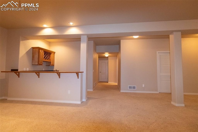 basement featuring light carpet