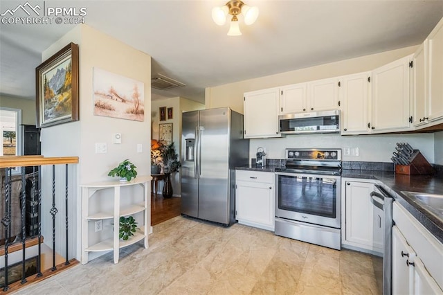 kitchen with white cabinetry and stainless steel appliances