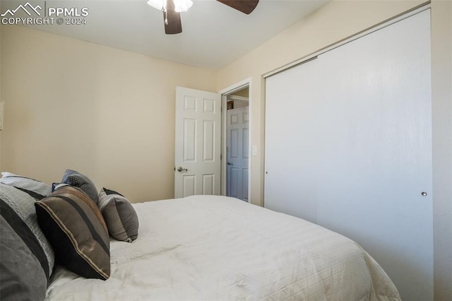 bedroom featuring ceiling fan and a closet