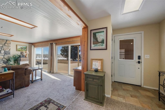 view of carpeted foyer