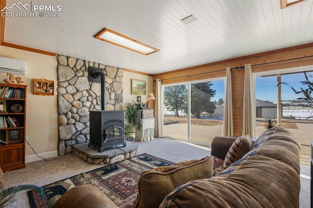 living room with a wood stove, carpet floors, a wall mounted AC, and ornamental molding