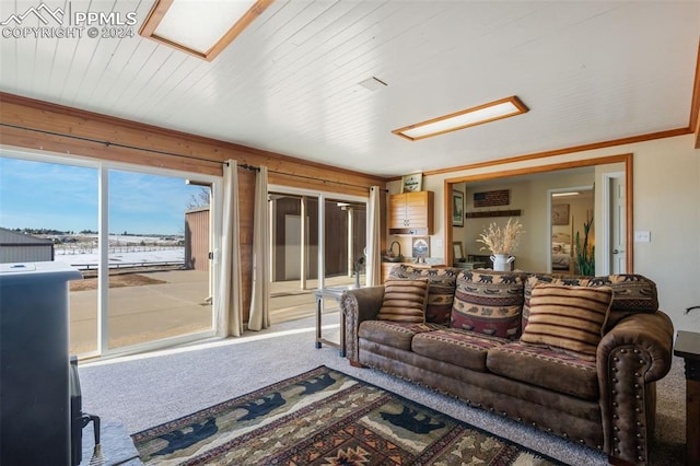 carpeted living room with wood ceiling and crown molding