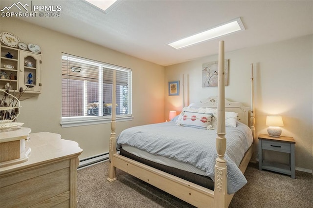 bedroom with baseboard heating and carpet