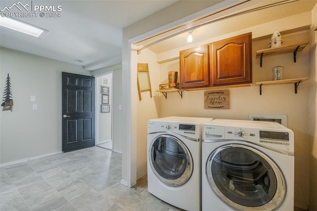 laundry area featuring cabinets and washing machine and clothes dryer